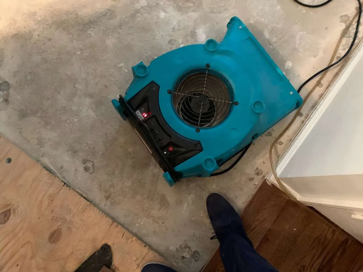 Air mover drying subfloor during Commercial Water Damage Restoration in Eagleton Village